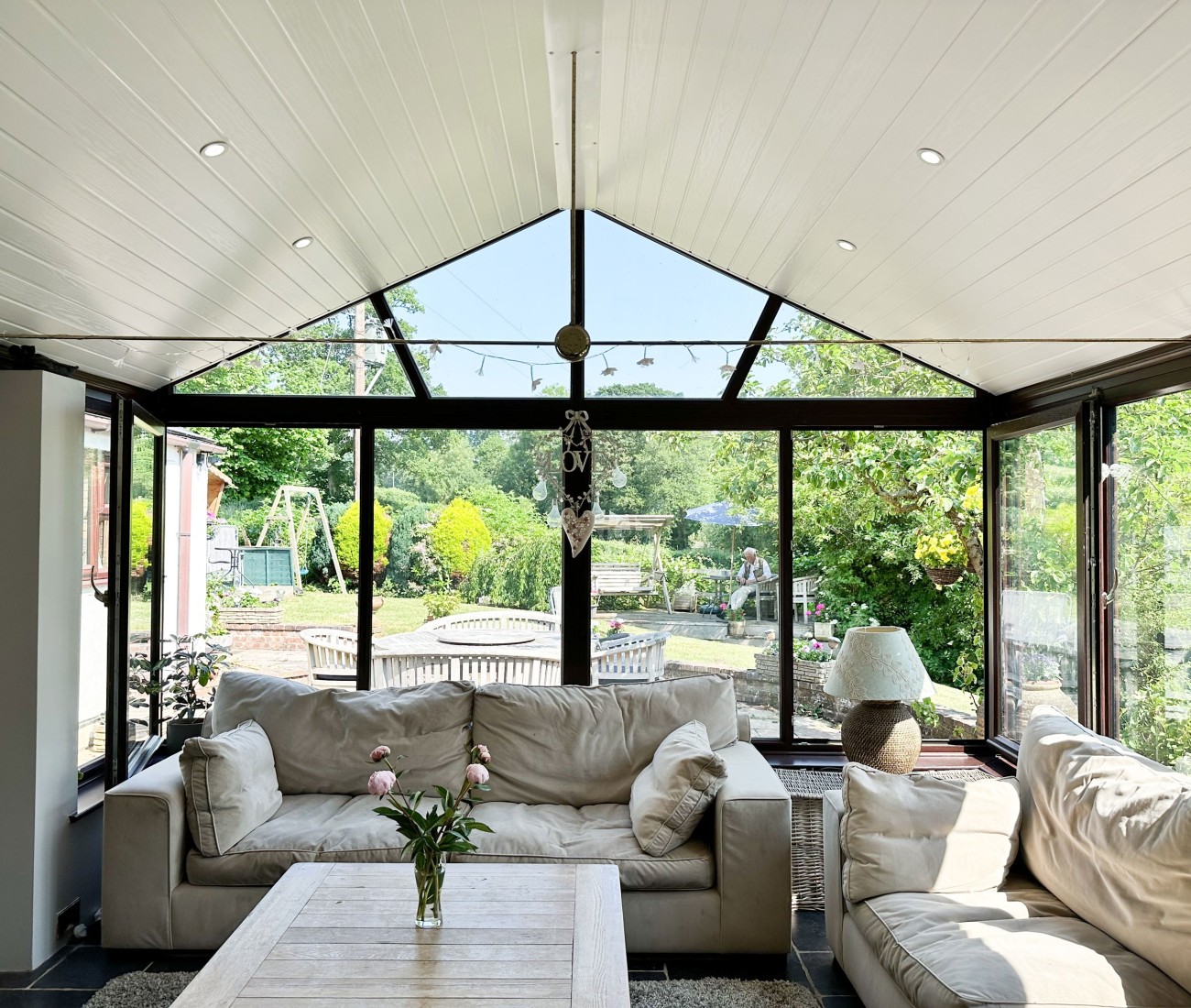 Conservatory fitted with CI Groups' insulation with a dining area and seating area